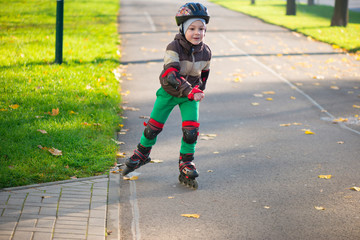 Happy little boy in sunny day on rolle