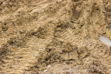 Truck tyre pattern on the frozen soil background