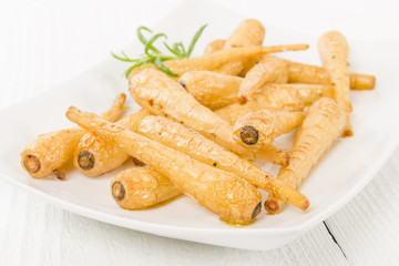 Parsnips - Honey roasted parsnips on a white background