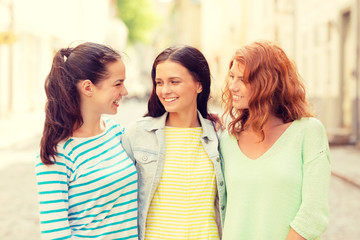 smiling teenage girls with on street