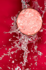 sausage in the water on a red background