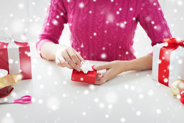 close up of woman decorating christmas presents