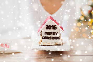 close up of woman showing gingerbread house