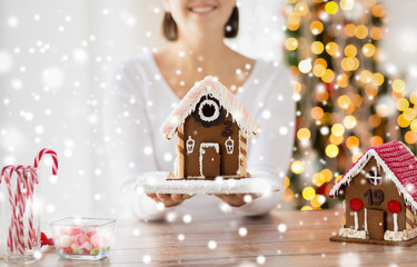 close up of woman showing gingerbread house