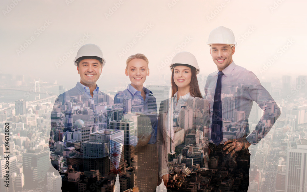 Wall mural happy businessmen in helmets over city background