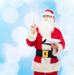 man in costume of santa claus with notepad