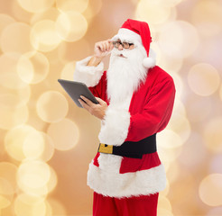 man in costume of santa claus with tablet pc