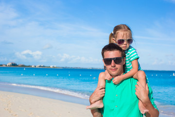 Adorable little girl have fun with dad during tropical beach