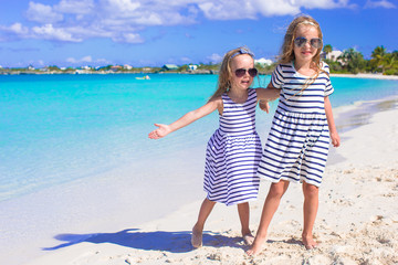 Adorable little girls enjoying summer beach vacation