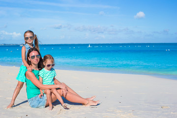 Little girls and happy mother during tropical beach vacation