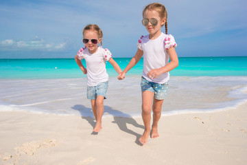 Little cute girls enjoy their summer vacation on the beach