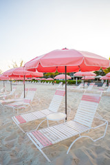 Tropical empty sandy plage with umbrella and beach chair