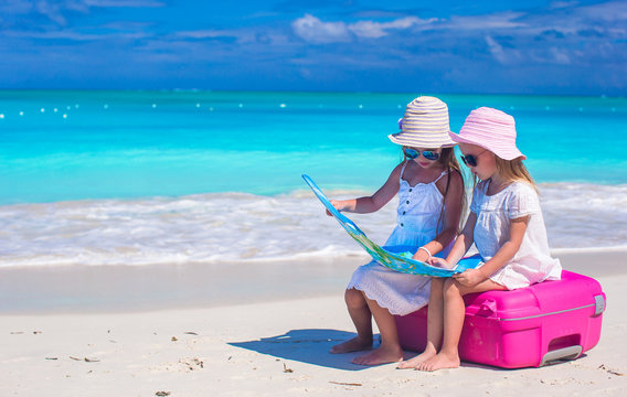 Little girls at tropical beach while summer vacation