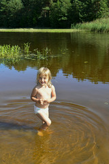 Little girl in water on sunny day