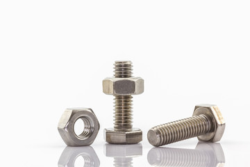 Metal screw and nuts on white background.