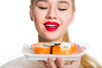 White-haired girl eating sushi with a chopsticks, isolated