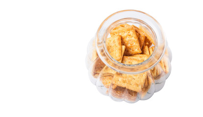 Sugar crackers or biscuits in a cookie jar over white background