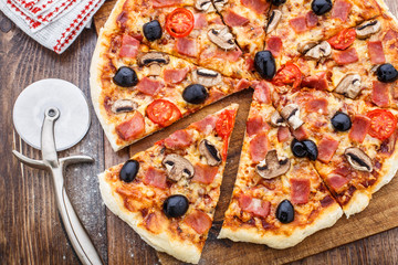 Pizza with ham, mushrooms and olives