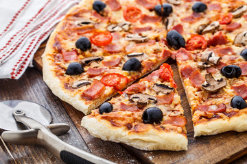 Pizza with ham, mushrooms and olives