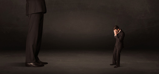 Obraz premium Huge man with small businessman standing at front concept