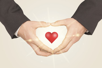 Hands creating a form with shining heart