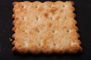 cookies crackers and crumbs on a dark background