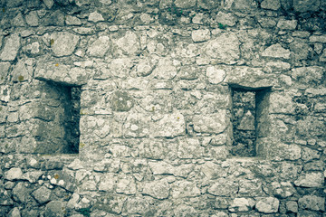 Windows in the old stone wall