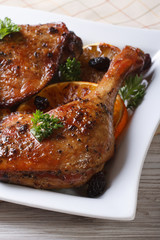 fried duck leg with oranges on a white plate, vertical