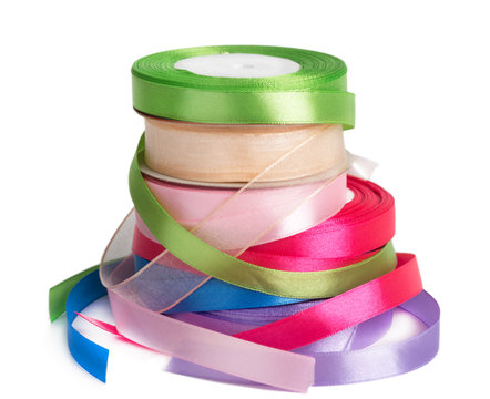 colored satin ribbons in a roll isolated