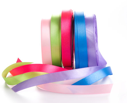 colored satin ribbons in a roll isolated