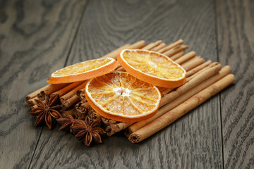 true cinnamon sticks and dried oranges