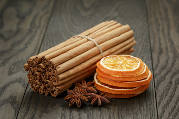 true cinnamon sticks and dried oranges