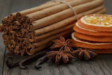 true cinnamon sticks and dried oranges