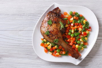 roasted duck leg with steamed vegetables horizontal top view