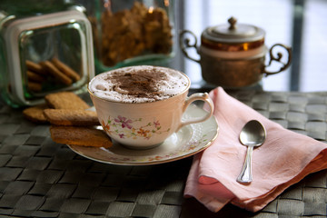Cup of cappuccino at home table