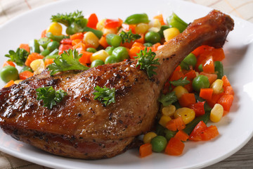delicious roasted duck leg with vegetables on white plate
