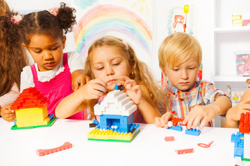 Fototapeta premium Group of kids playing with plastic blocks