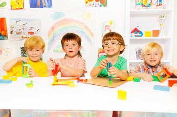 Group of kids in the class with toy tools