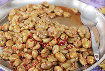 spicy marinated olives, on the counter market in the large plate