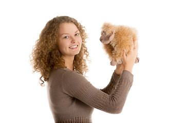 Girl plays with stuffed toy sheep