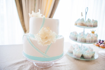 Fototapeta na wymiar wedding cake with individual decoration at withe table