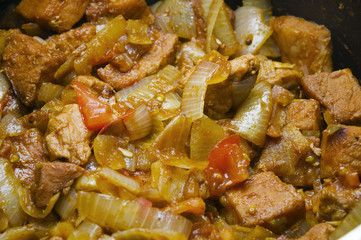 meat onions and tomatoes in a pot