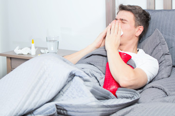 mann mit grippe im bett