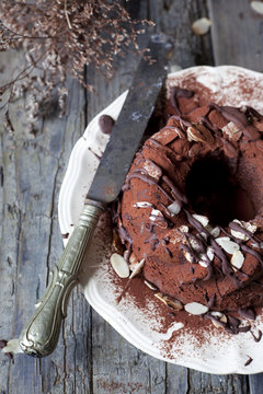 chocolate ring-shaped cake covered with chocolate and almonds
