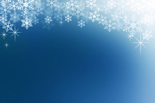 Snow flakes on midnight blue abstract winter background.