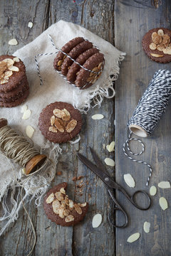 homemade gingerbread and almonds cookies on rustic table