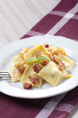 Portion of ravioli with onion and bacon
