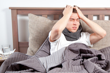 mann mit grippe im bett