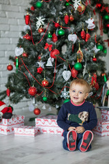 Kid near new-year tree