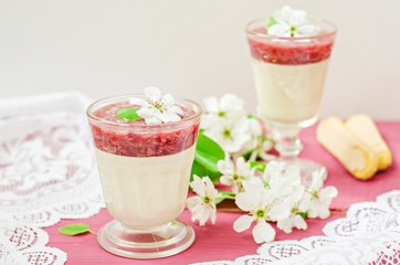 White chocolate dessert with strawberry mousse in glasses on spring background. Selective focus on...